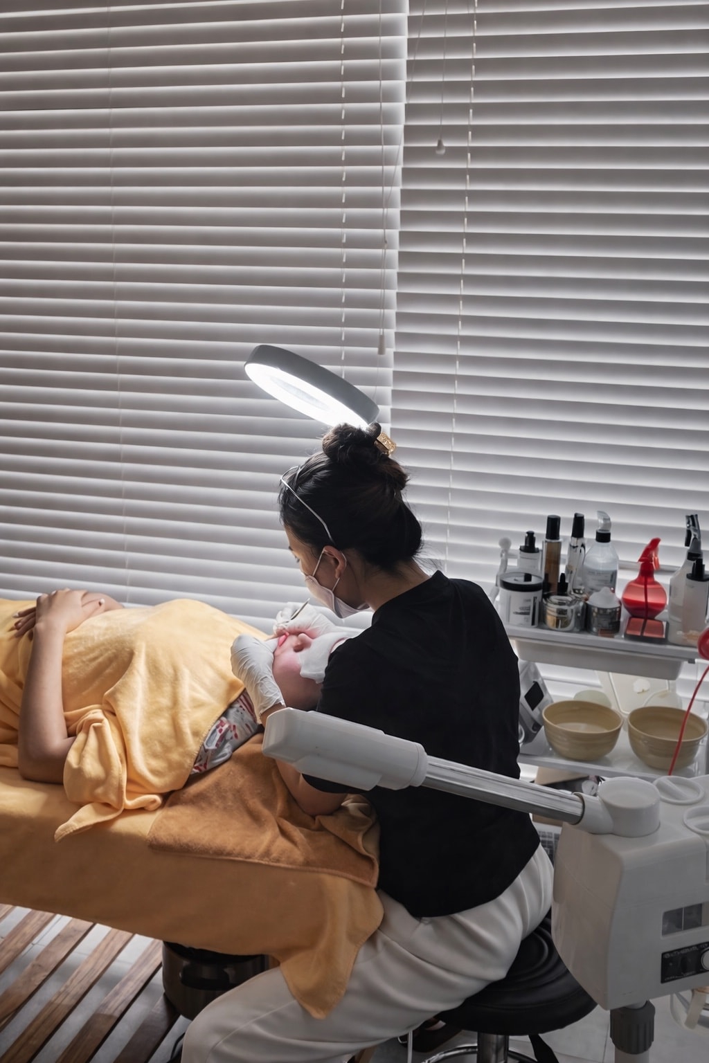 Esthetician performing a lash treatment